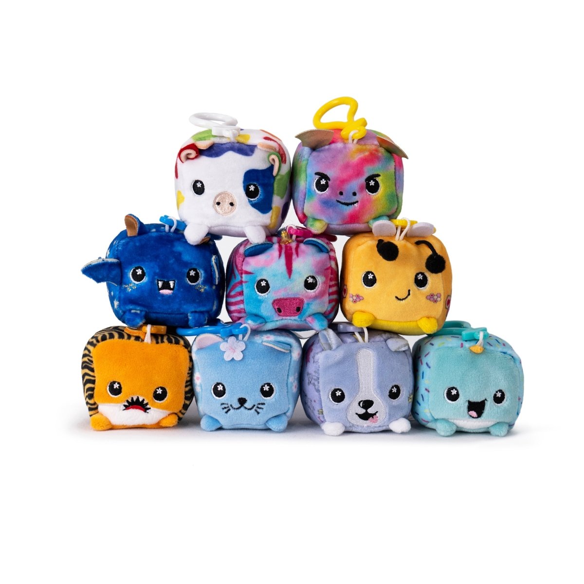 A pyramid of ten colorful, cube-shaped plush toys from the Moosh-Moosh Series 1 features delightful animal designs with unique patterns and playful expressions—horns, ears, whiskers included. Among them is Hex the Bee Square Plush Clip-On. They're arranged in three tiers against a white background.