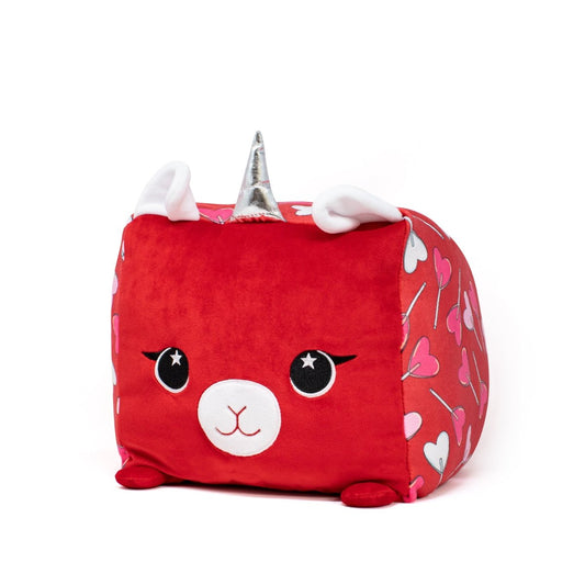 Introducing Amora the Llamacorn Plushie, a charming red square unicorn toy. It boasts a silver horn, white ears, and an adorable face. Adorned with pink heart patterns, it's the perfect Valentine's Day gift!.