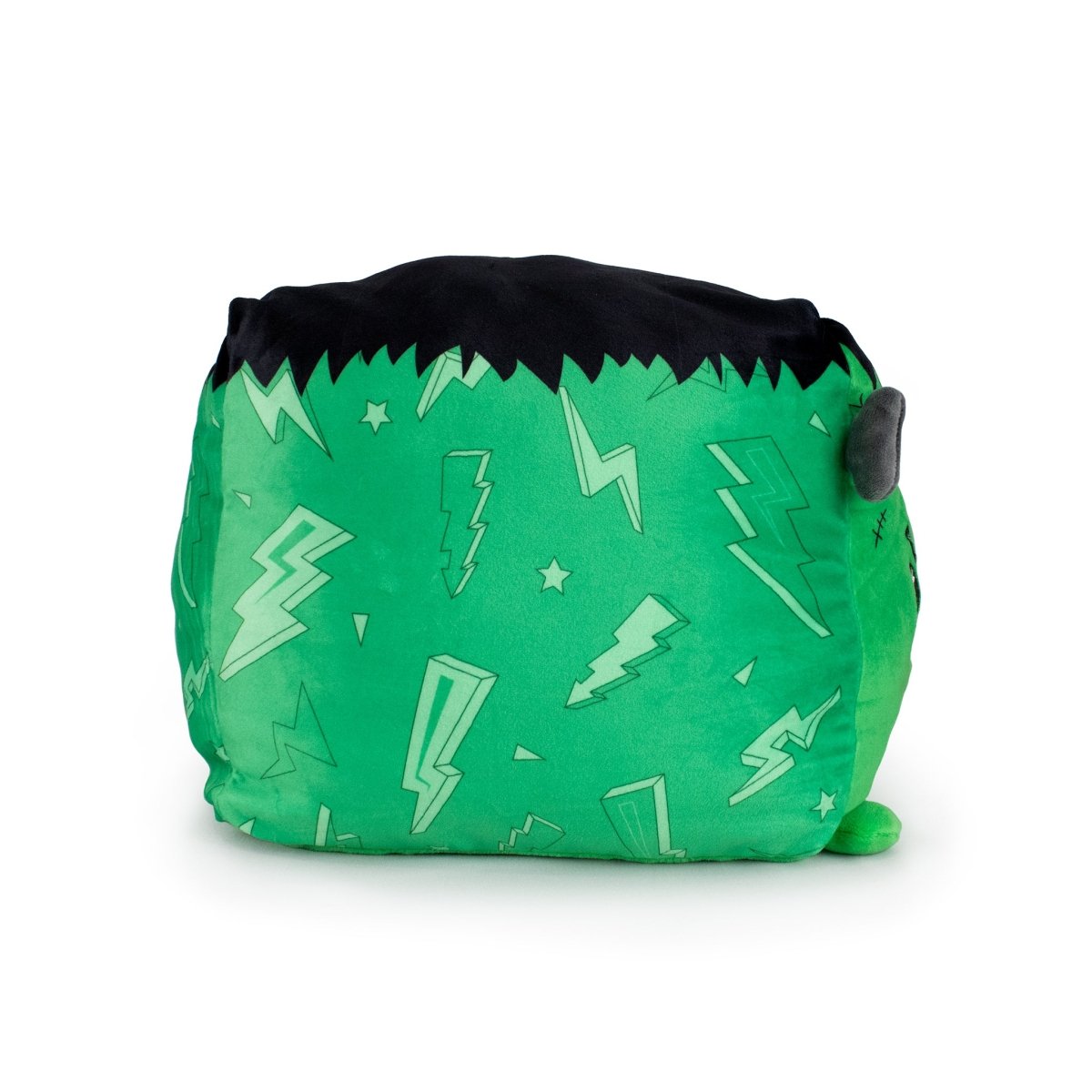 Boris the Monster is a green, ultra-soft plush pillow with black hair-like fabric on top, decorated with light green lightning bolts and stars. Its square shape with rounded edges and a small ear makes it perfect for cuddling or collecting.