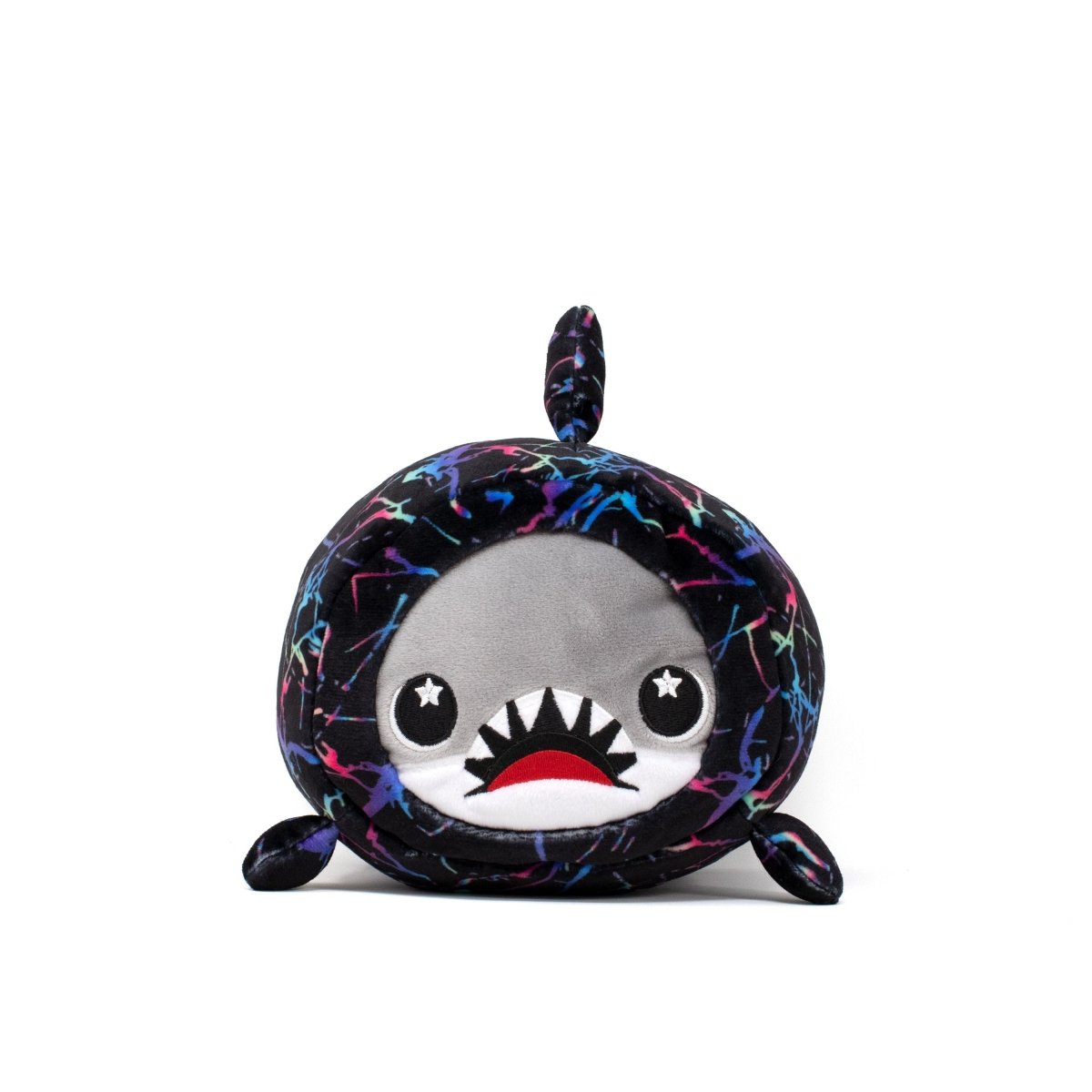 The Crush Slumber Plushie is a soft, round toy shark featuring star-shaped eyes, a wide-open smile, small fins, and a tail. Its body boasts a colorful design that gives it a cute and playful cartoonish look.