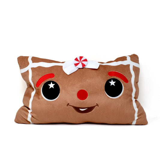 Melani the Gingerbread Pillow features a smiling gingerbread face with big black eyes, red eyebrows, a red nose, white icing details, and a peppermint bow—perfect for sensory squishing and festive holiday decor.