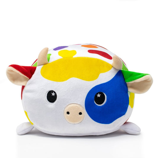 Introducing Clara the Cow Plushie: a cuddly toy with a round body and colorful patches in yellow, blue, green, and red. Featuring small horns, starry eyes, beige ears, and a cute pink snout, Clara exudes playful charm.