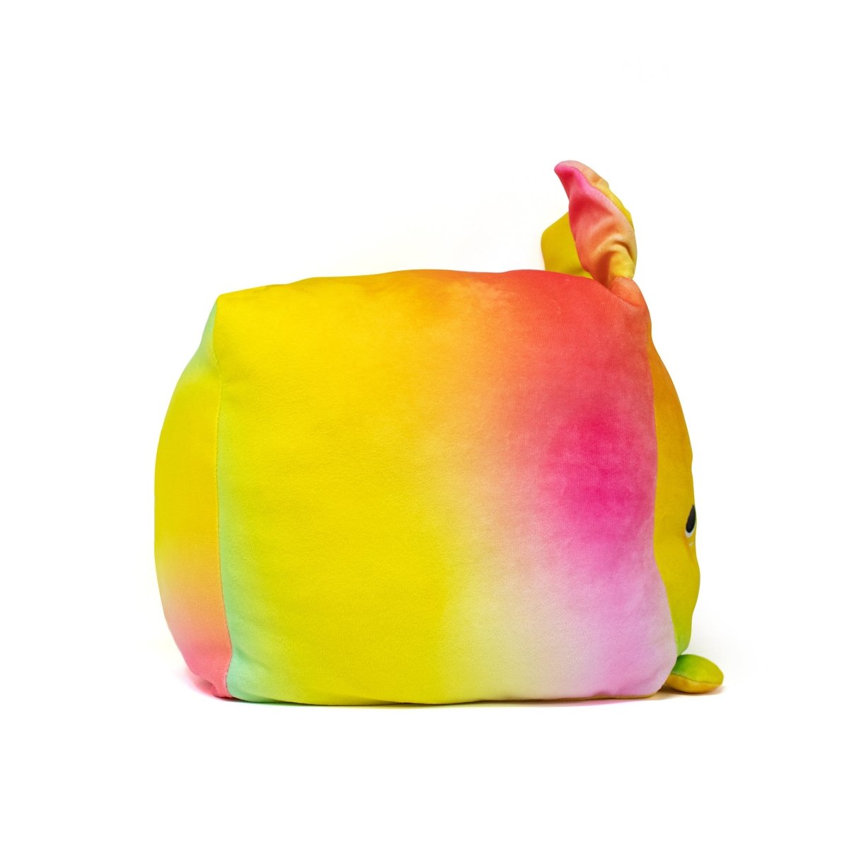 Introducing Coco the Bunny Plushie, a soft plush toy with a vibrant gradient blend from yellow to pink to orange. It features small ears and a rounded square shape, sitting charmingly against a white backdrop.