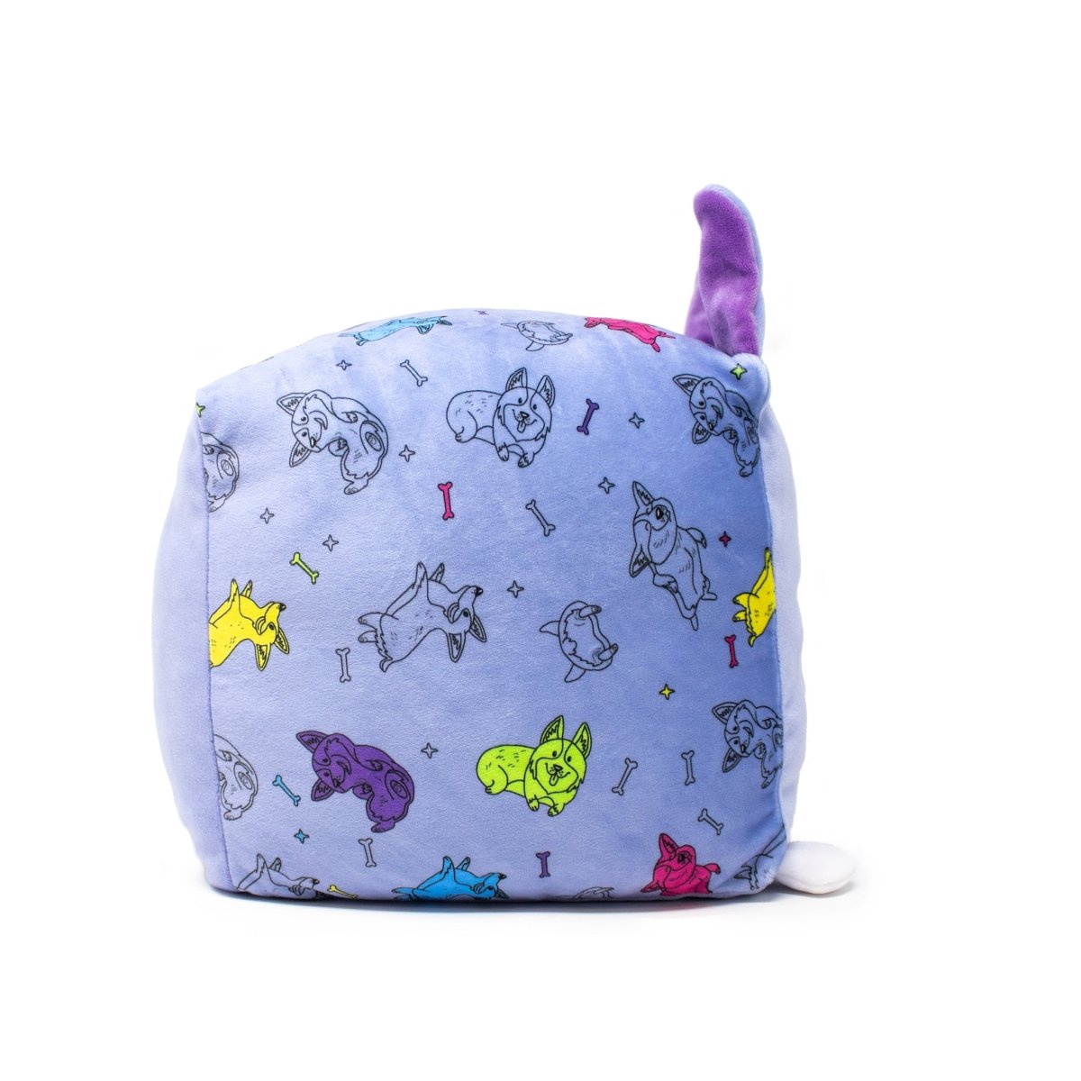 Connie the Corgi Plushie, a cube-shaped pillow with a light blue background, features colorful cartoon corgis and bones. With a purple ear and small round white tail, this cuddly toy has a playful design and is machine washable for easy care.