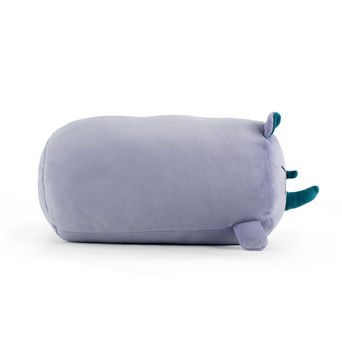 Dane the Rhino is a plush, cylinder-shaped toy with light purple fur, two small teal horns, and tiny purple ears, shown lying on its side against a white background.