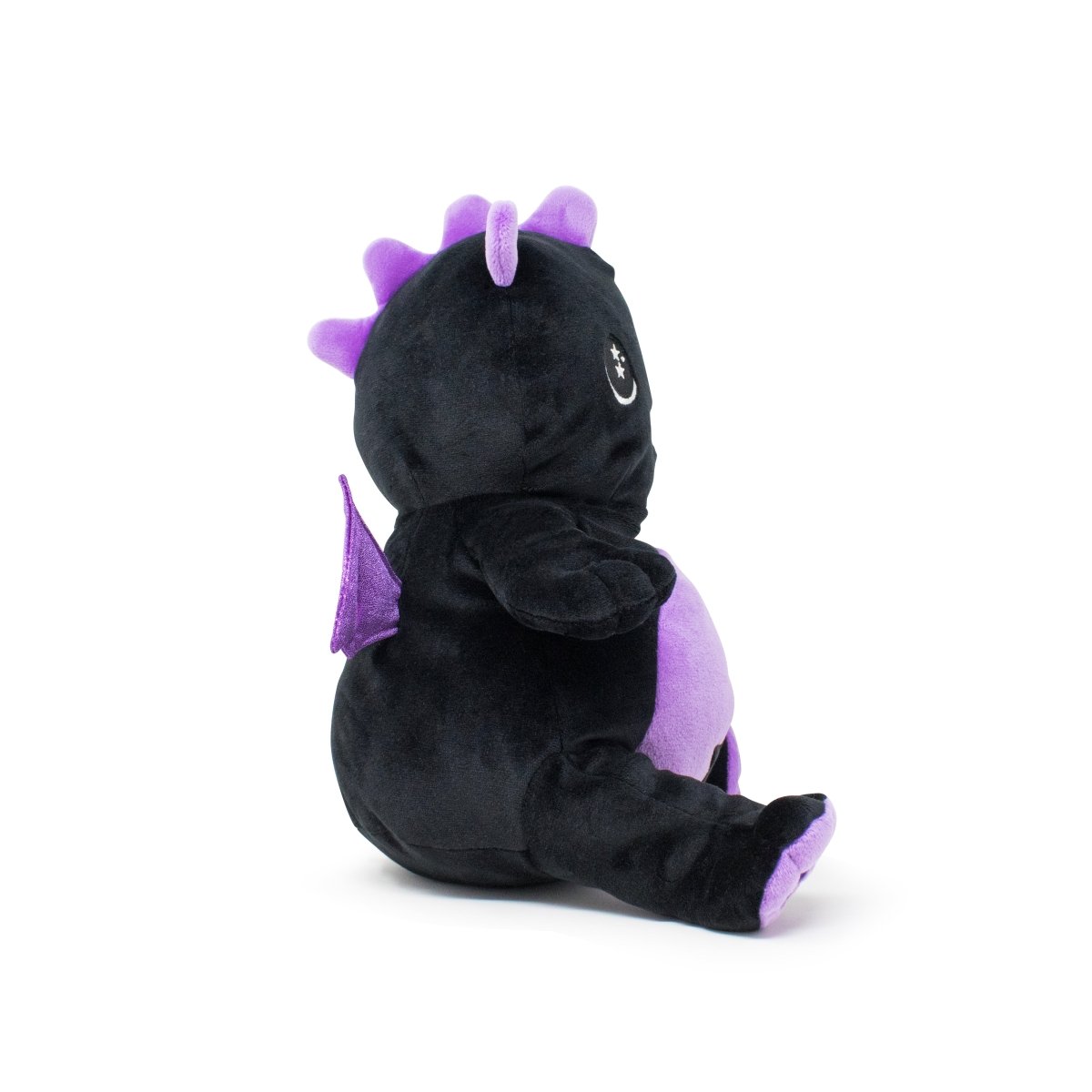 Kai the Dragon Plushie Starlight Buddy is a cute toy with a black body, purple belly, and spikes. It has small purple wings and sits upright facing slightly to the right.