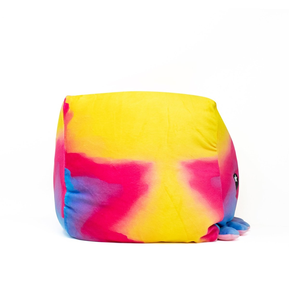 Eve the Octopus Plushie is a colorful cube-shaped toy with a gradient of yellow, pink, and blue. It features round black eyes, little legs at the base, and offers sensory softness making it extra cuddly against its plain white background.