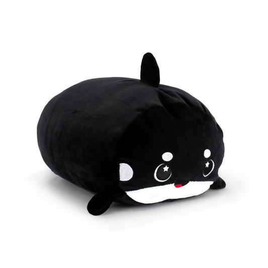 Fausto the Orca is a plush toy shaped like a black and white whale, featuring a cute face with rosy cheeks, starry eyes, and a small fin on top.