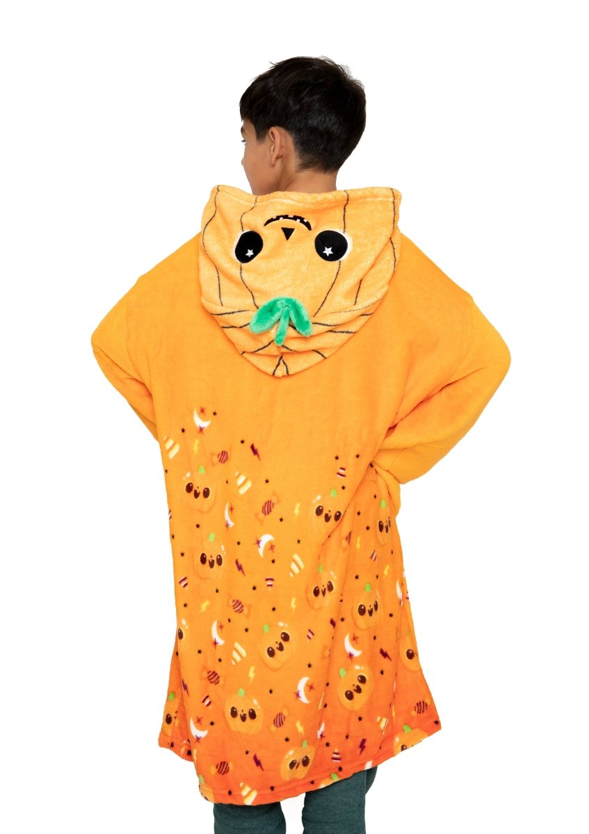 A child stands facing away, wrapped in the Vincent the Pumpkin Hooded Blanket with a cute animal face, ears, and leaf on the hood. This cozy kids’ fleece blanket features small playful patterns for extra charm.