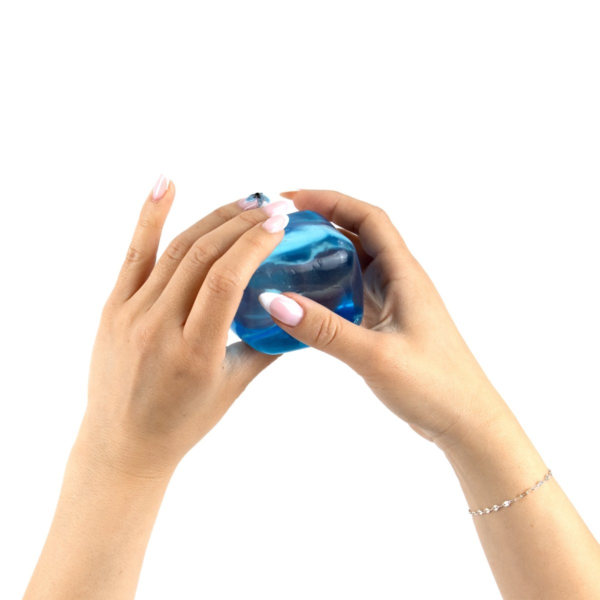 Two hands with manicured nails hold and squeeze Bubblegum's Favorite Toy - Solid Sugah-mals Cubes against a white background.