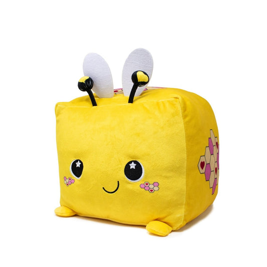 Introducing Hex the Bee Plushie, a cube-shaped yellow toy featuring a charming smile, starry eyes, and pink cheeks. It boasts small ears, antennas with white tips, and honeycomb patterns on its sides that highlight its honey-making charm.