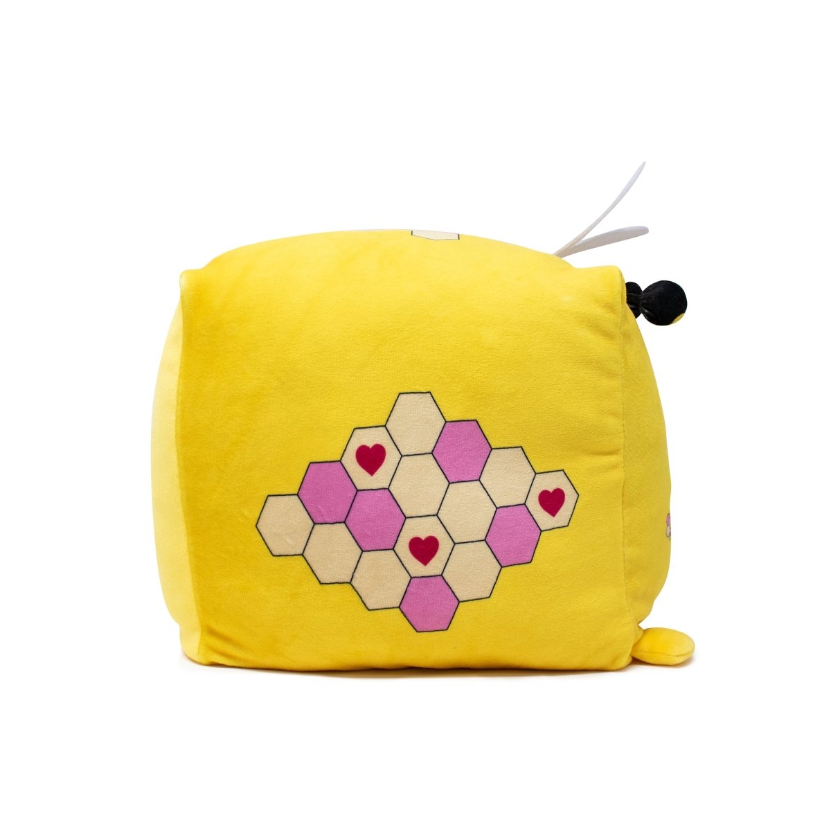 Introducing Hex the Bee Plushie: a yellow plush cube with a honey theme, featuring pink and beige hexagon patterns, heart shapes at the center, and charming small black and white details.
