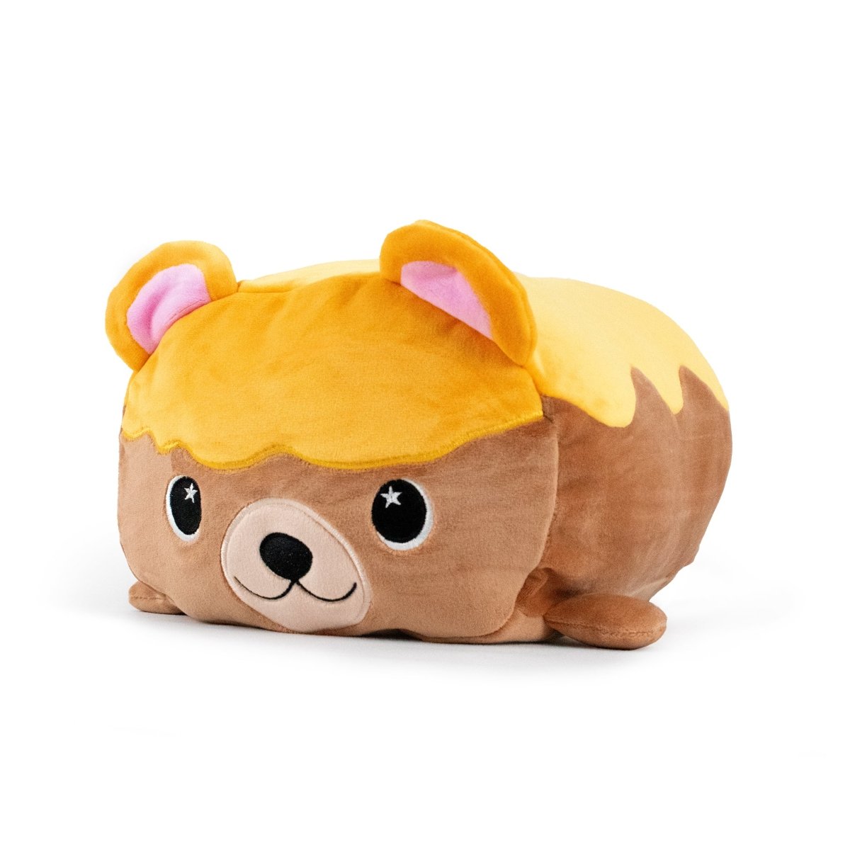 Meet Honey the Bear, a loaf-shaped plush toy in the Moosh-Moosh family with a golden-brown crust-like top, pink ears, and an adorable face with big eyes and a small smile—perfect for cuddling.