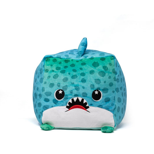Houdeenie the Leopard Shark Plushie, a square blue plush toy with a spotted design, features a sensory-soft texture. It has black eyes with white stars, a triangular top fin, and a wide mouth with red lips and visible teeth. It's machine washable for easy care against a plain white background.