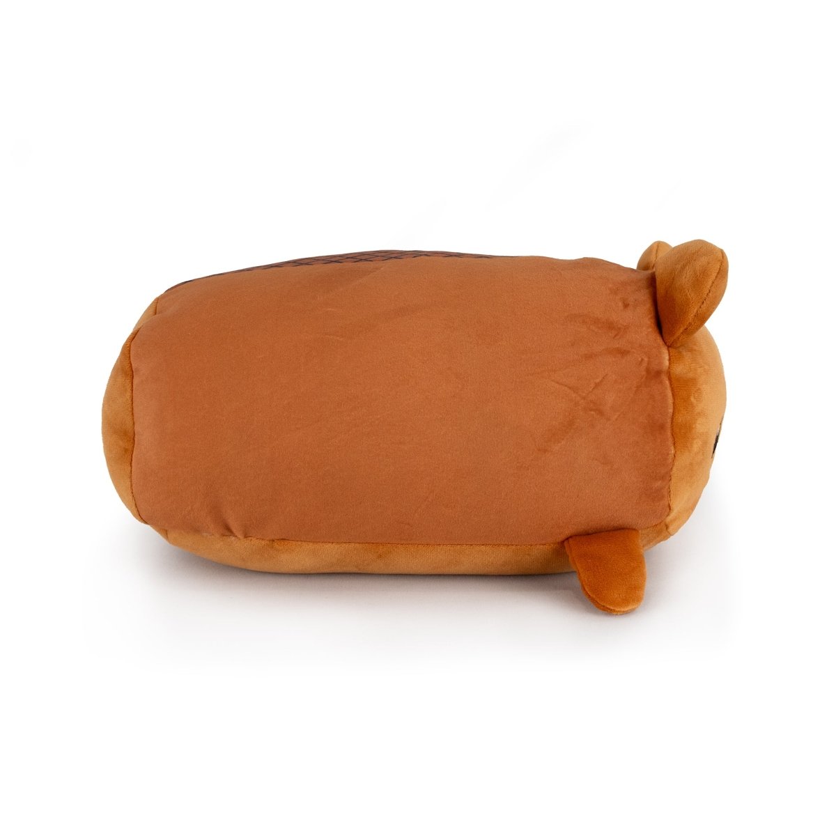 Justice the Beaver is a plush toy shaped like a loaf of bread, featuring a brown top, small round ears, and a tiny tail, shown lying on its side against a white background.