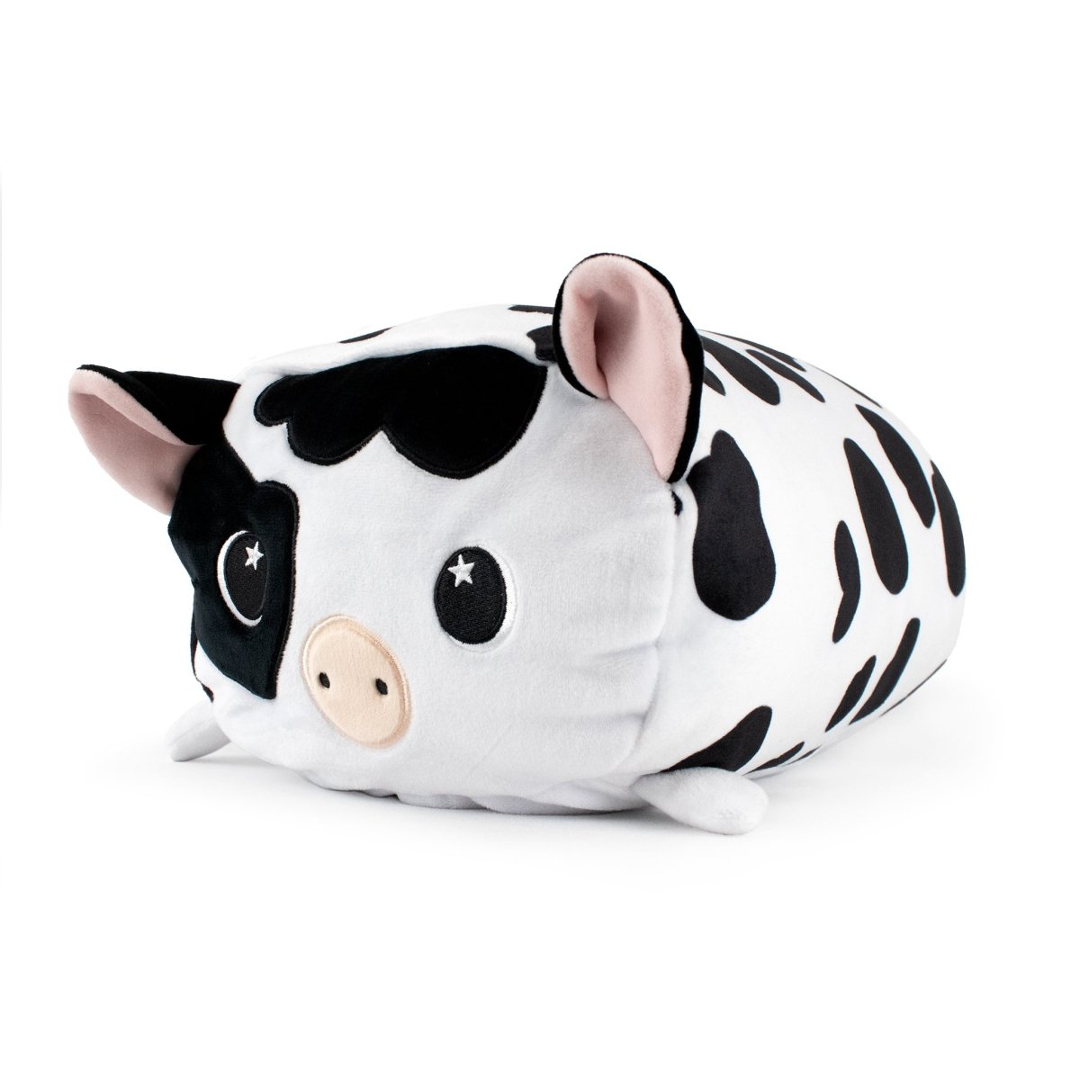 Leche the Cow Plushie is a soft, rounded stuffed animal with black and white spots, cute eyes, and tiny ears, resting on a white background.