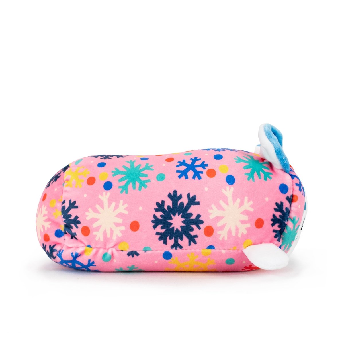 Snowie the Snow Leopard Slumber is a pink Christmas plush toy with colorful snowflake and polka dot patterns, small white and blue fins, and a blue tail—perfect for festive holiday decorations.