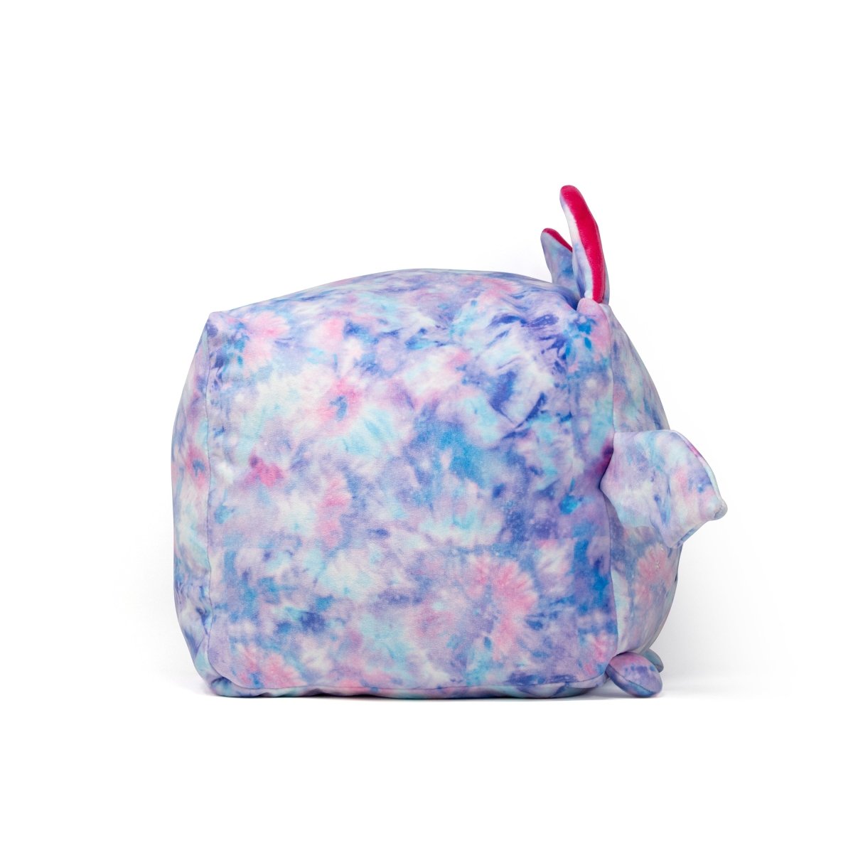 A cube-shaped plushie named Lyra the Bat features tie-dye patterns in blue, purple, and pink. It includes small ears, fins, a tiny tail, and is set against a plain white background.