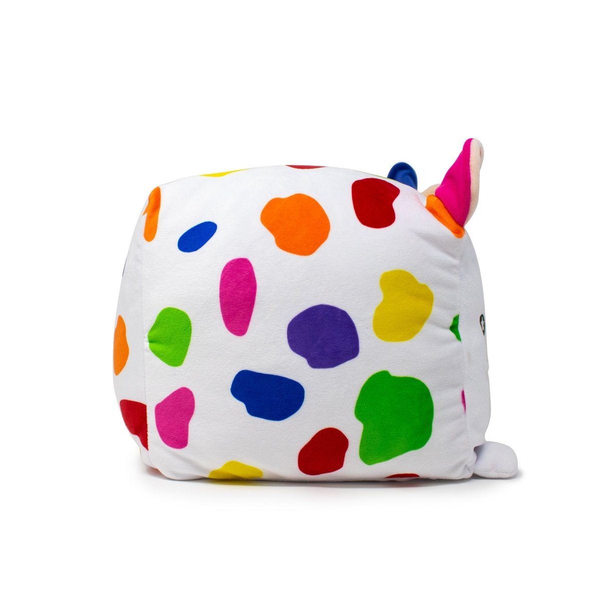 Introducing Milly the Cow Plushie, a square-shaped stuffed toy with colorful spots in pink, green, purple, blue, yellow, and red. This playful plush features small ears on top and a soft white fluffy texture for an abstract design.