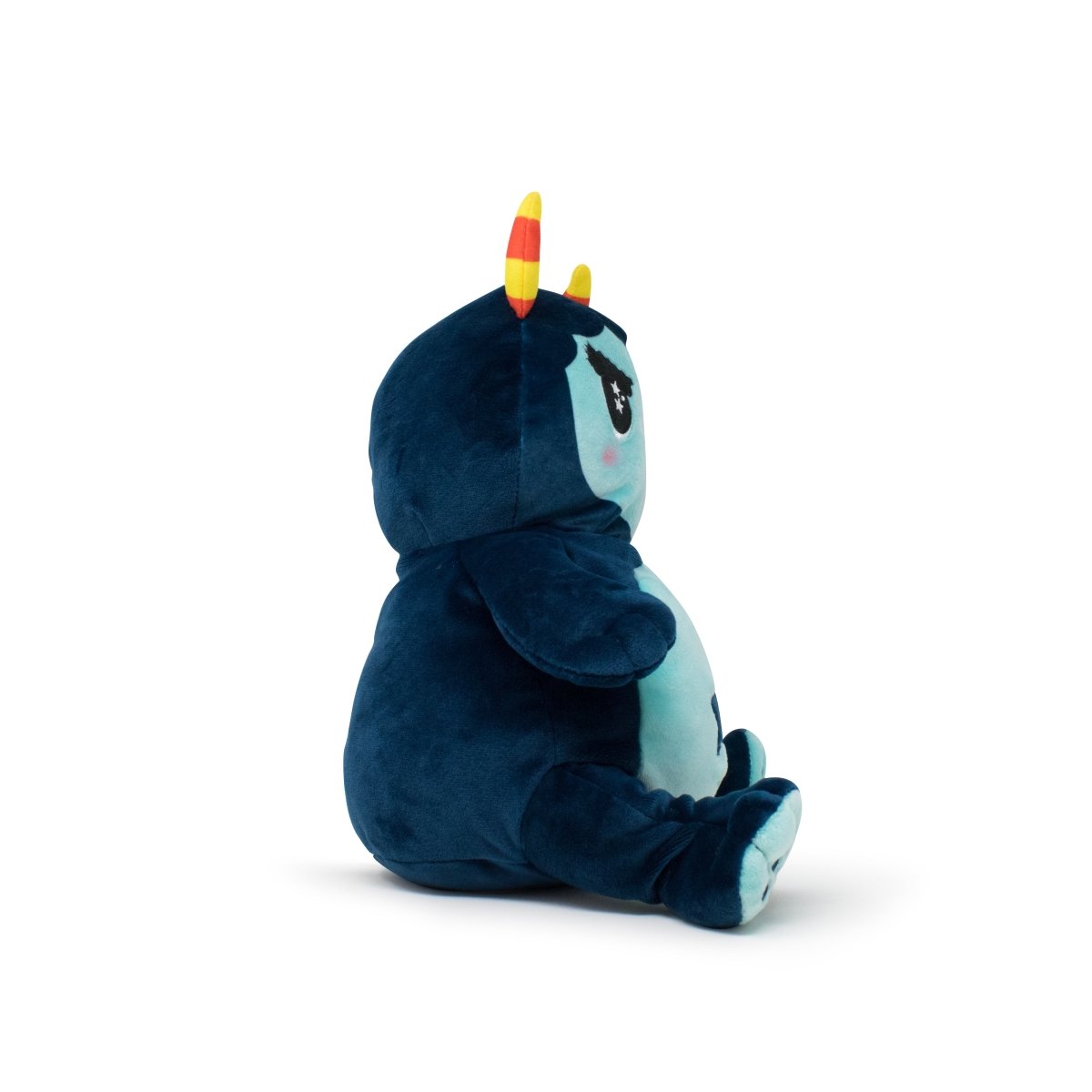 Spike the Monster Plushie Starlight Buddy is a blue plush monster with yellow and red striped horns, small wings, and a light blue belly, shown sitting and facing right.