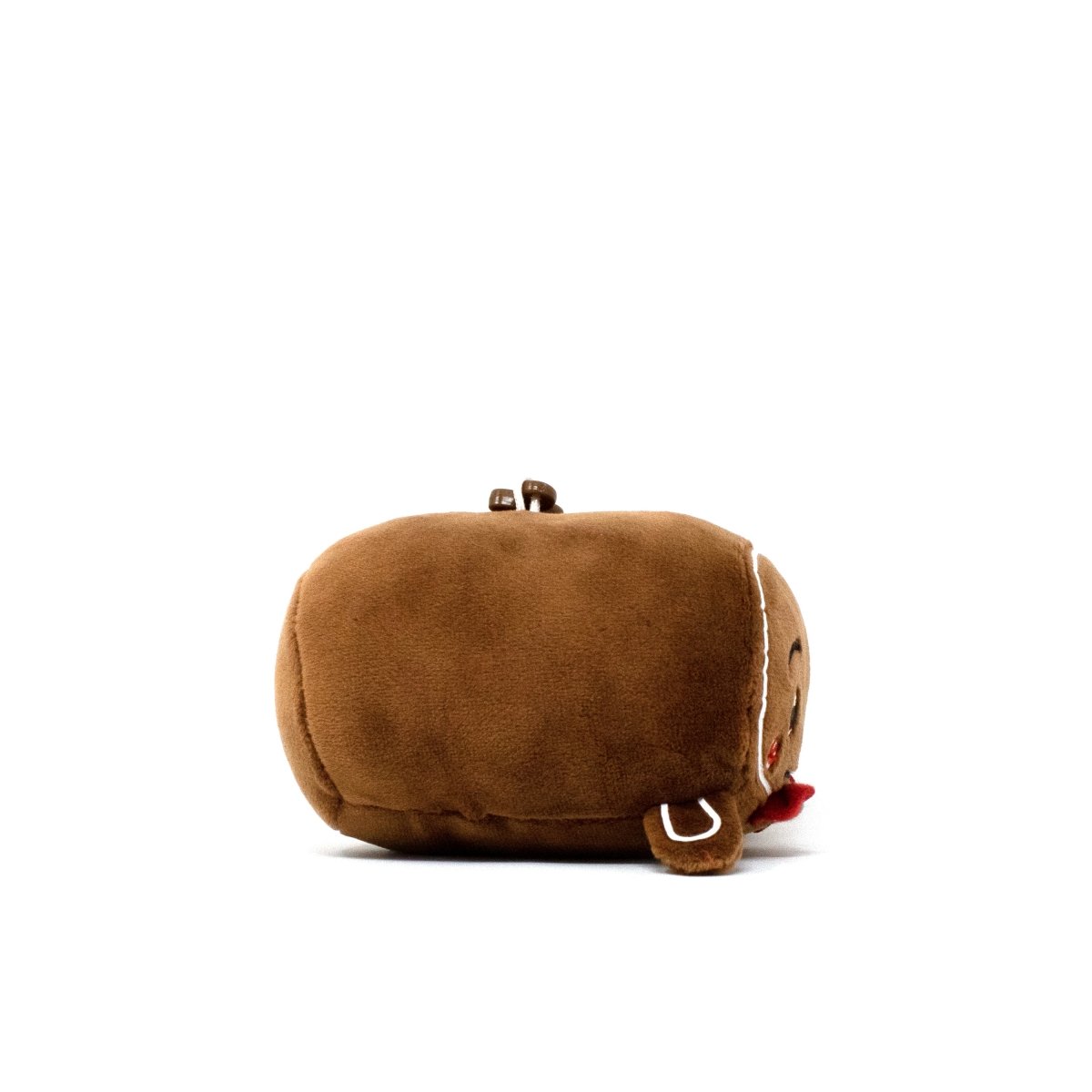 The Gingersnaps Clip-On is a small, round, brown plush keychain shaped like a gingerbread cookie with a smiling embroidered face and red tongue, shown lying on its side against a plain white background.