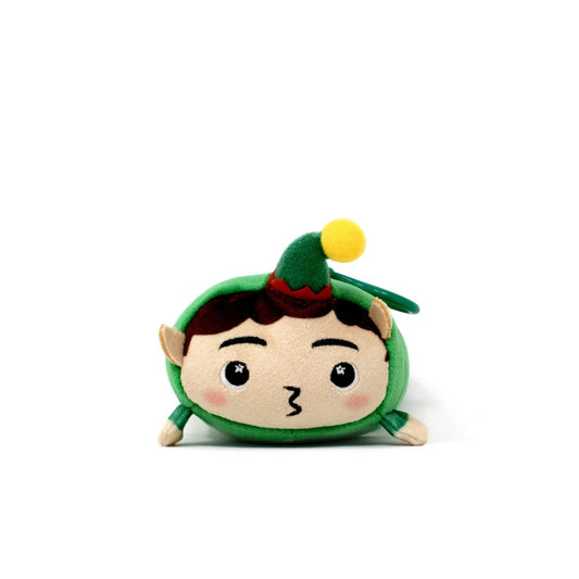 Jingle the Elf Clip-On is a small, round holiday plushie with a green hat, yellow pom-pom, pointy ears, and a puckered mouth, shown sitting on a white background.