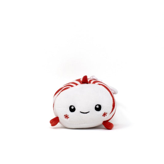 Mintie the Mint Clip-On is an adorable plushie designed like a peppermint candy, showcasing red and white stripes, a happy face, and little red arms, cheerfully set against a plain white backdrop.