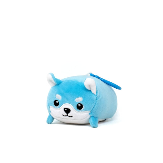 A cute plush toy resembling a small, round blue dog is actually Yuki the Snow Fox Clip-On. It features white facial accents, small pointed ears, and an adorable expression, showcased on a plain white background.