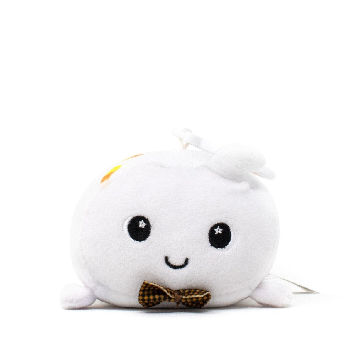 Boo the Ghost Clip-On is an adorable white plushie featuring round eyes, a smiling face, and a tiny bow tie. Its soft, round body and stem-like top create a charming contrast against its plain white background.
