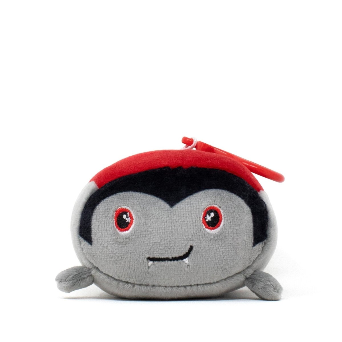 Bram the Vampire Clip-On from the Moosh-Moosh Spooky Series is a small, pocket-sized plushie with a black widow's peak, red eyes, tiny fangs, and a red clip on top—perfect for spooky style on the go.