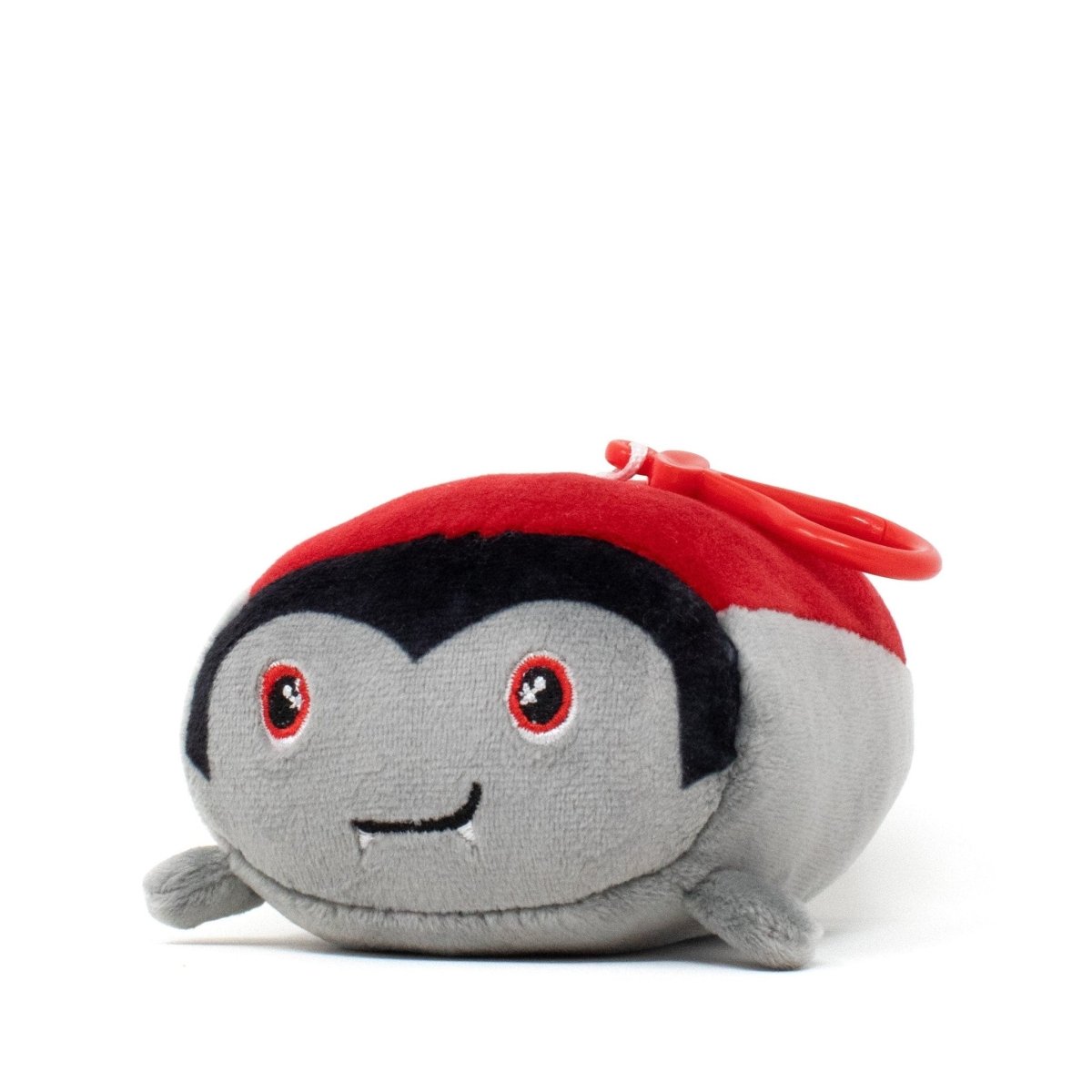 Bram the Vampire Clip-On is a small, pocket-sized plushie from the Moosh-Moosh Spooky Series, featuring red eyes, fangs, black hair, and a red clip on top, shown against a white background.