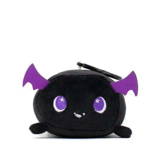 Cassie the Bat Clip-On is a soft, cute plush coin purse shaped like a black bat with purple wings and big purple eyes, featuring a small smile and a keychain on top, all displayed against a plain white background.