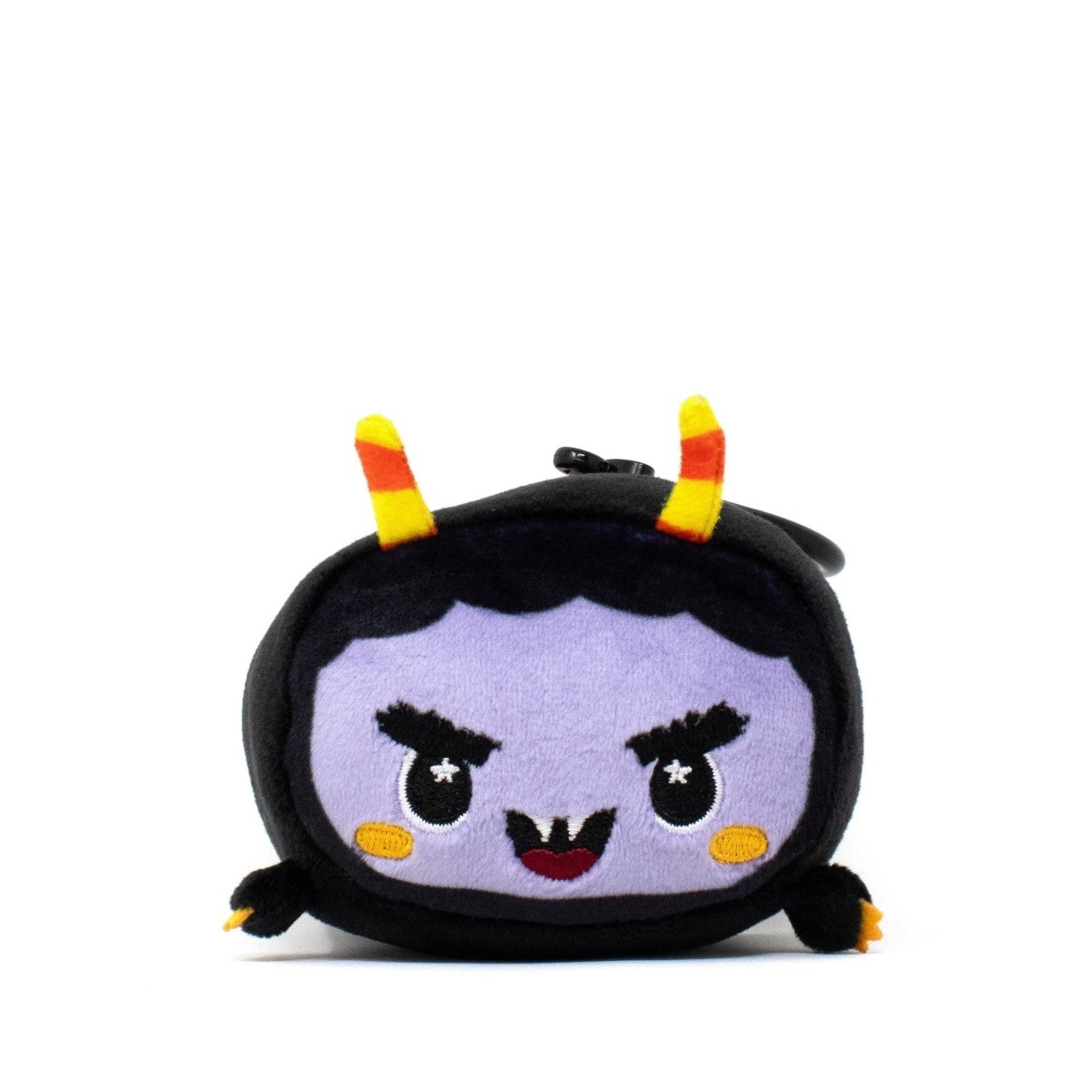 Fang the Monster Clip-On, from the Moosh-Moosh Spooky Series, is a small plush with a purple face, black hair, yellow-and-orange striped horns, sparkly embroidered eyes, a smile, yellow cheeks, and mostly black body.