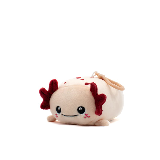 Cael the Axolotl Plush Clip-On is an ultra-soft, maroon-gilled plush toy with a light beige body, smiling face, starry eyes, and pink cheeks. Its charming round shape makes it perfect for Valentine's Day or as an adorable accessory.
