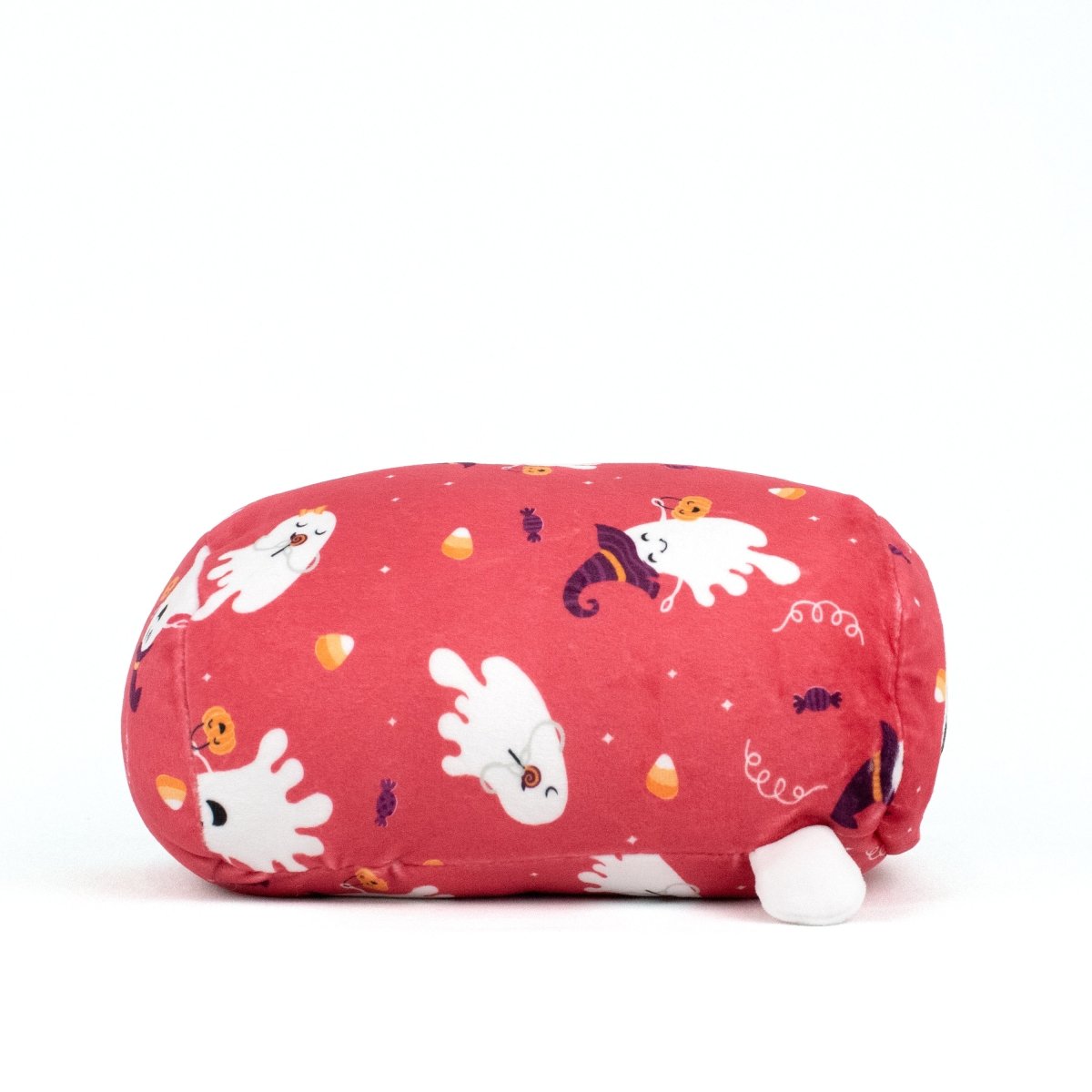 The Boo Spooky Slumber Plushie is a pink oval-shaped pillow made from ultra-soft material, featuring cute white ghosts, candy corn, pumpkins, and other Halloween designs. It is shown on a plain white background.