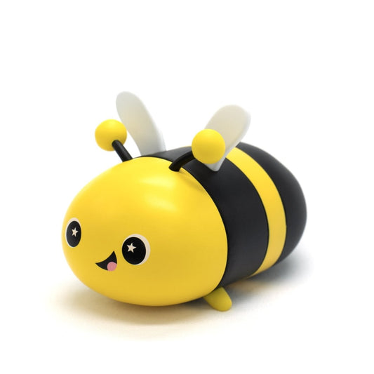 The Vee the Bee Vinyl Collectible Figurine features a cute cartoon design with yellow and black stripes, a smiling face with star-shaped eyes, small wings, and antennae—perfect for Moosh-Moosh collectors!.