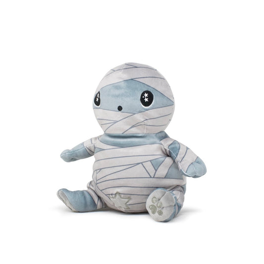 Nile the Mummy Plushie Starlight Buddy is a soft, cute plush toy with light gray bandages and big black eyes featuring star patterns. It sits upright on a white background with a small star on its foot.