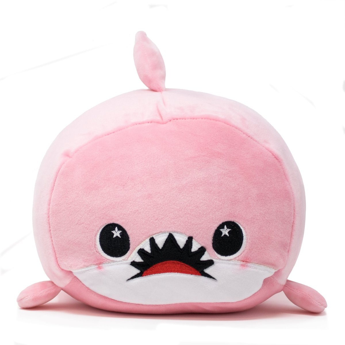 Nibbler the Pink Shark Plushie is an adorable, round figure with a small dorsal fin, wide dark eyes featuring star-shaped highlights, and a friendly open mouth with white teeth. It has a soft white belly on its cuddly body, set against a plain white background.