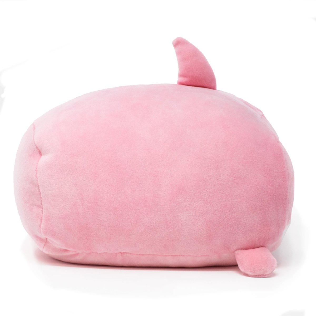 Nibbler the Pink Shark Plushie, a soft round stuffed toy, resembles a stylized whale with a small dorsal fin and two side flippers, sitting against a plain white background.