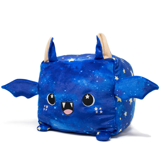 Orion the Bat Plushie is a soft, square toy with small wings and pointy ears. It features a blue, starry pattern and adorable facial details, including big eyes and a smiling mouth with fangs.