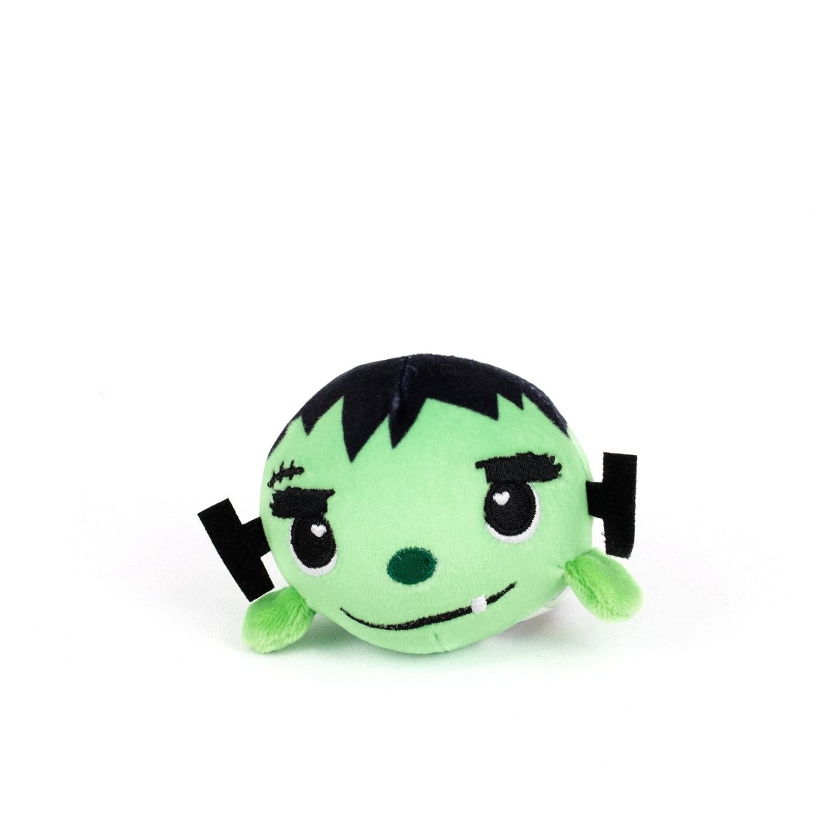 The Frankie Spooky Plushy Skwishy is a round, cute green monster plush with black hair, stitched eyebrows, a scar, and small black and green ears, styled to look like a cartoon Frankenstein's monster.