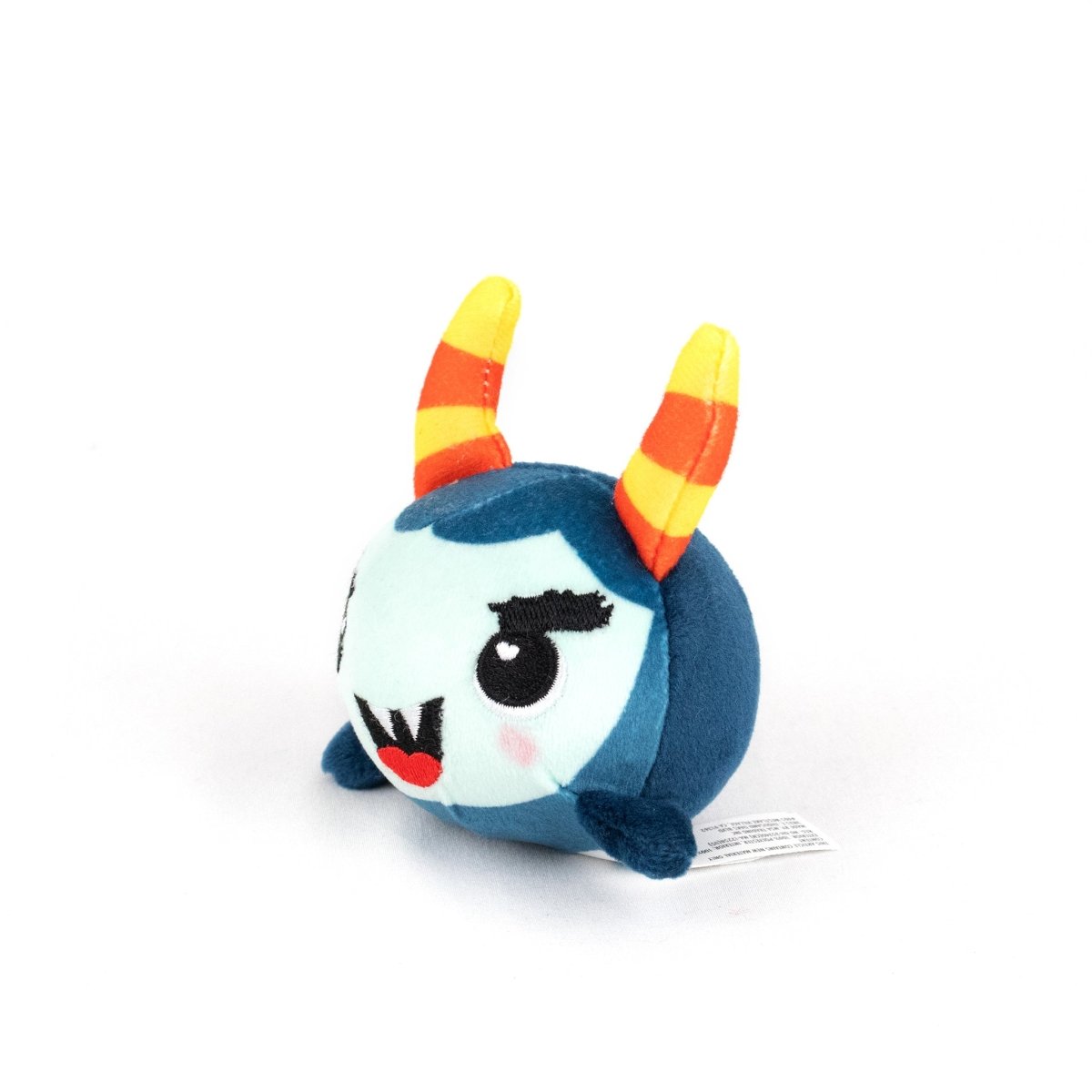 Spike Spooky Plushy Skwishy is a round, blue plush toy with orange and yellow striped horns, black eyelashes, a red mouth, and small flipper-like arms, shown on a white background.