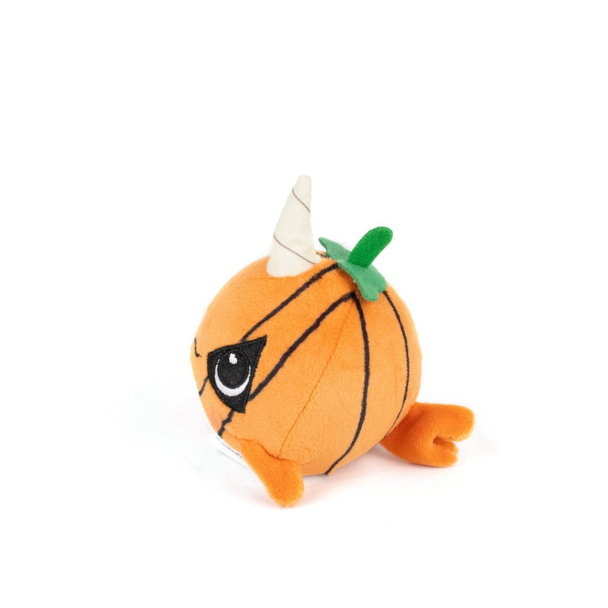 The Vincent Spooky Plushy Skwishy is a soft, round orange pumpkin plush toy with black stitched lines, cartoon eyes, a white horn, green stem on top, and small orange arms and legs.