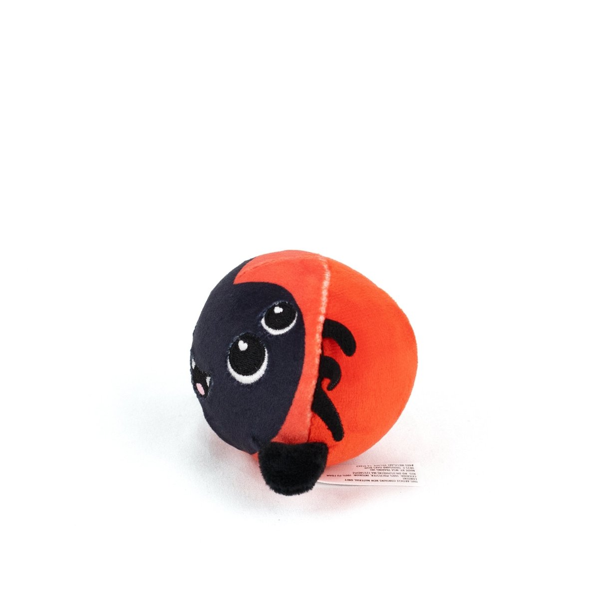 The Muffet Spooky Plushy Skwishy is a round plush toy with a smiling face, big eyes, and black spots on its red body, shown on a white background.