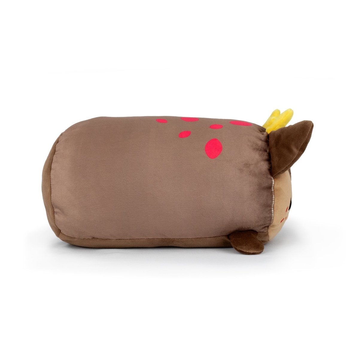 Praline the Reindeer—a plush pillow shaped like a brown deer with yellow antlers, felt ears, and red spots—lies on its side against a white background.
