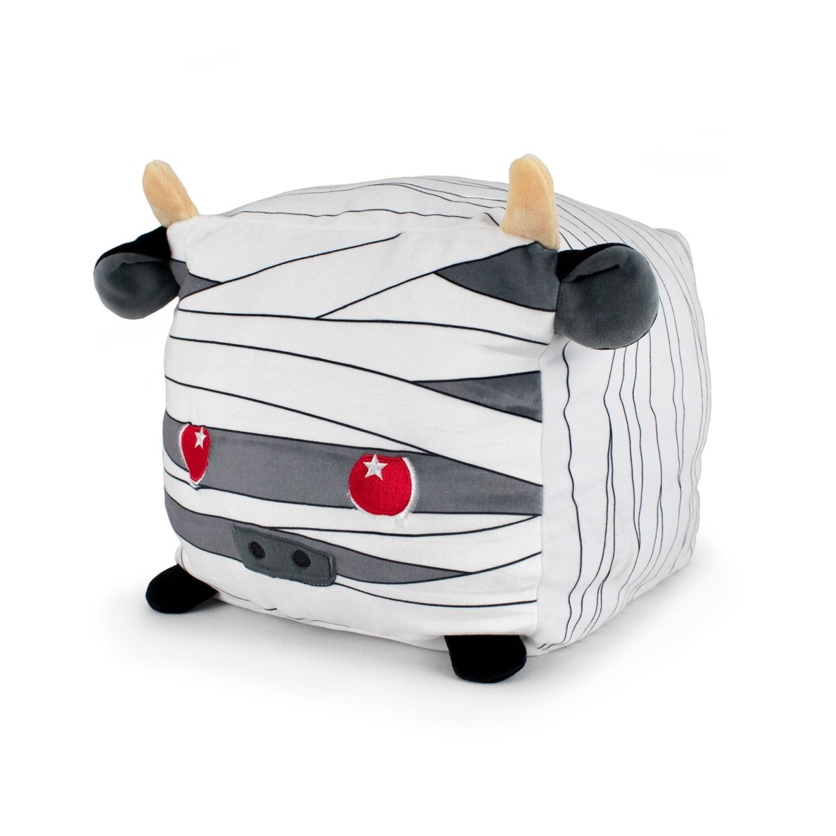 Ramsey the Sheep Mummy is a plush, cube-shaped toy with white fabric and gray stripes like mummy bandages. It features beige horns, red eyes, black nostrils, ears, and feet for a cute, wrapped-up look.