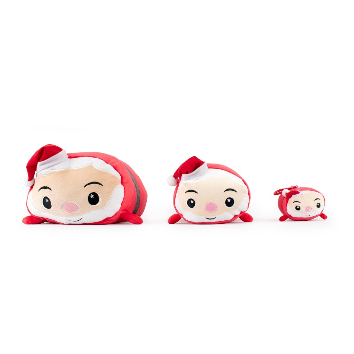 Three Santa Clip-On plushies with Santa faces and red hats line up by size on a white background. The smallest Santa Clip-On is a keychain, accented with a red bow next to its festive hat.