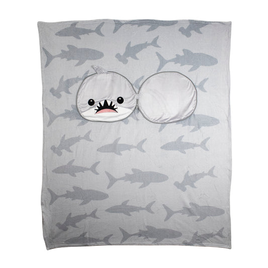 The 2-in-1 Pillow Blanket - Crush the Shark is a gray blanket with shark silhouettes and a sewn-on hood shaped like a cartoon shark head, featuring a wide open mouth and cute eyes.