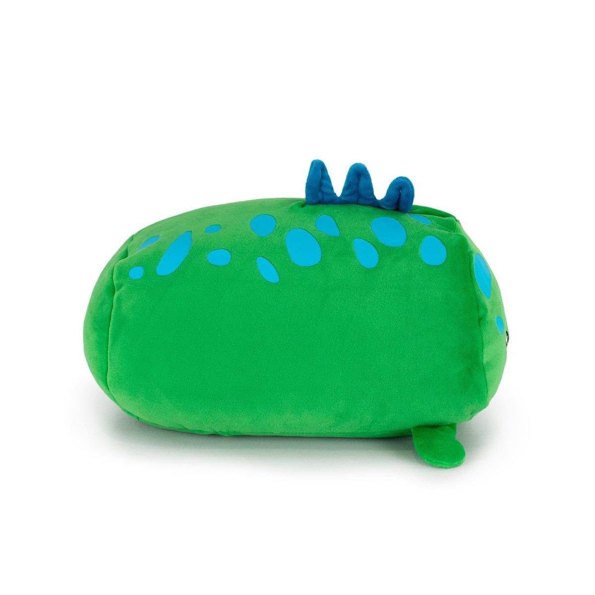 Sinclair the Dino, a plush toy shaped like a green dinosaur with blue spots and three blue spikes on its back, is shown lying on its side against a white background.