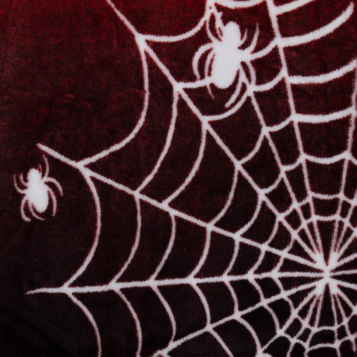 The Muffet the Spider Hooded Blanket features a bold Halloween design with white spiderwebs and spiders on a dark red background, making it a cozy and stylish choice for warmth during the spooky season.
